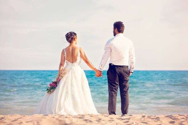 istock Wedding couple by the ocean. 1183604006