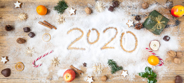 istock 2020 year's figure written in snow with christmas decoration 1183604323