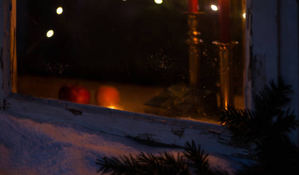 istock Looking into a Christmas window with burning candles in winter 1183604999