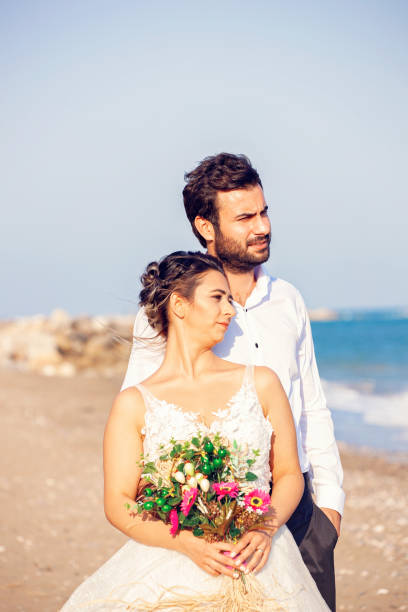 istock Wedding couple by the ocean. 1183605395
