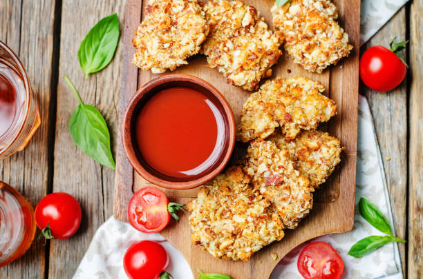 istock almond crusted chicken tenders with tomato sauce 1183606853