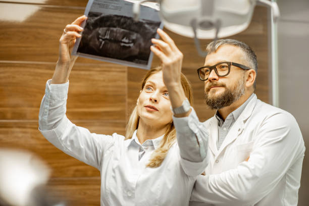 istock Dentists examining x-ray image at the office 1183607202