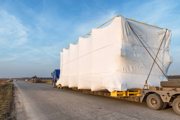 Truck with large oversized cargo on rural road Truck with large oversized cargo on rural road. Industrial wide angle landscape too big stock pictures, royalty-free photos & images