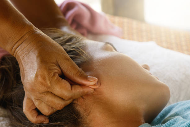 ear massage - reiki alternative therapy massaging women imagens e fotografias de stock