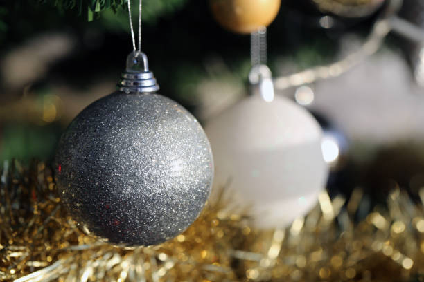 istock Shiny Christmas Ornaments Hanging from a Christmas Tree Branch 1183610666