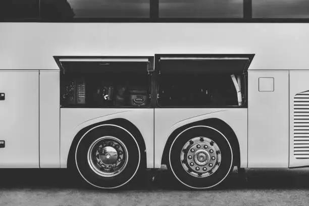 classic intercity bus with open trunk in black and white colors