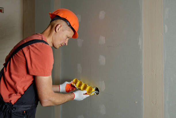 istock Making holes in the drywall. 1183615148
