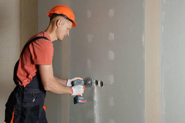 istock Making holes in the drywall. 1183615149