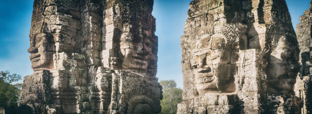 Buddha faces in Bayon temple in Angkor Thom. Siem Reap. Cambodia. Panorarma Buddha faces in Bayon temple in Angkor Thom at morming time. Siem Reap. Cambodia. Panorarma panorarma stock pictures, royalty-free photos & images