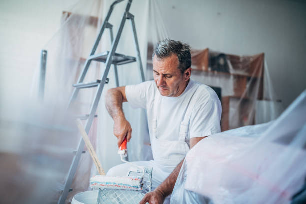 istock Senior man painting his home 1183619293