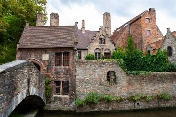 Old stone houses along riverbank in old Flanders town of Bruges