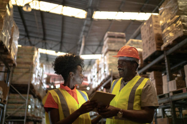 istock Father and daughter or coworker using tablet at warehouse 1183631734
