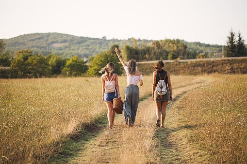 Three female friends exploring nature on the outskirts of their town