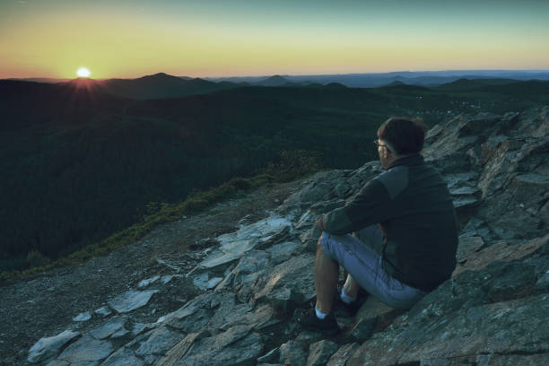 istock Man enjoying morning and looking to orange daybreak 1183634496