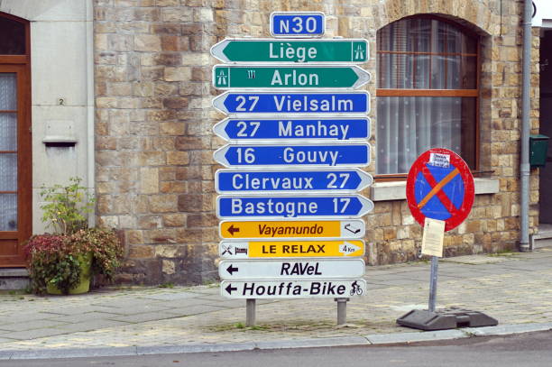 Houffalize,, Belgium - October 22, 2019: Multiple Belgian traffic direction signs in the town center of Houffalize.