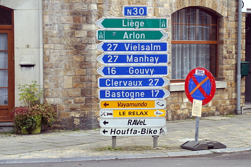 Houffalize,, Belgium - October 22, 2019: Multiple Belgian traffic direction signs in the town center of Houffalize.