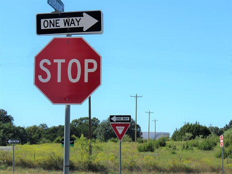 traffic signs: stop, one way, yield ; copy space