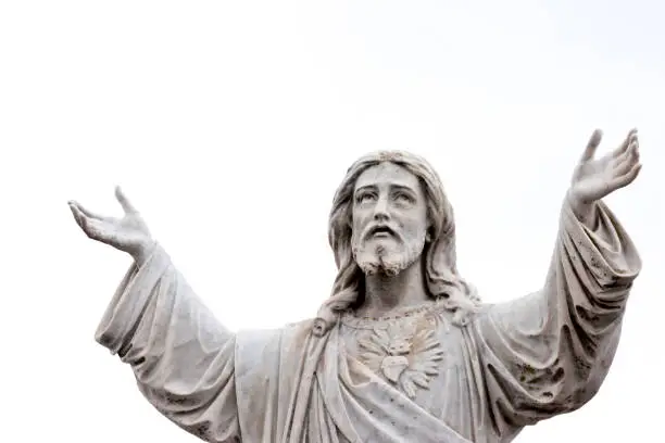 Photo of Old staue of Jesus Christ, sky background with copy space