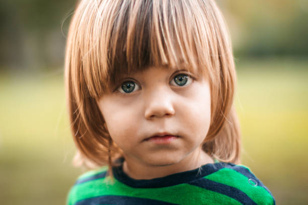Cute blonde baby boy looking at camera