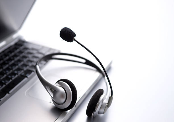 istock Silver microphone headset sitting on a laptop mouse pad 118365206