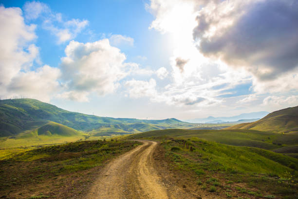 istock Dirt road to the open mountain 1183654636