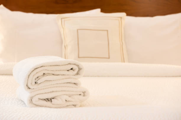 istock White towel on bed in hotel room 1183654713