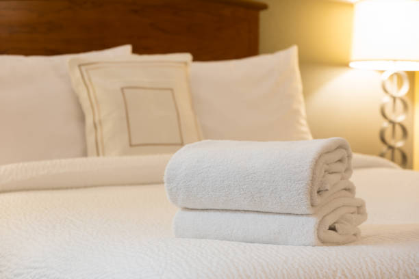istock White towel on bed in hotel room 1183654715