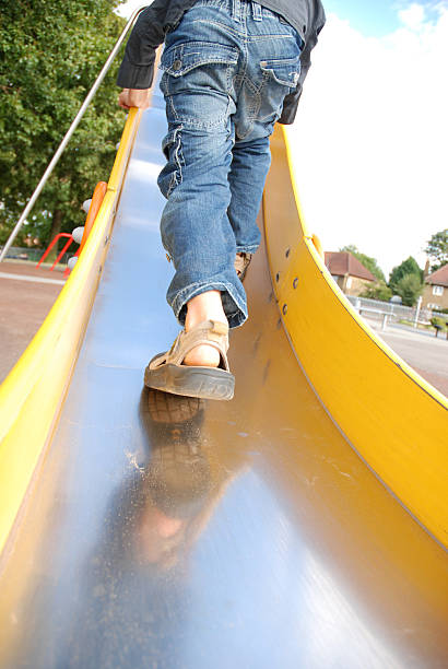 Little boy having his feet tickled whilst laughing
