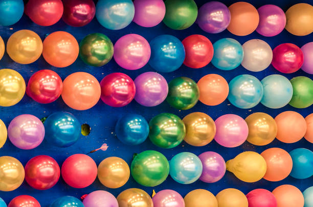 A background of brightly coloured balloons.