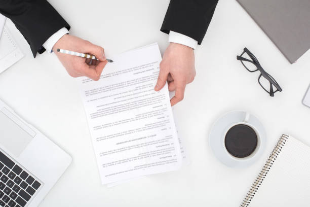 istock Young business man sitting at the table top view taking notes 1183657199
