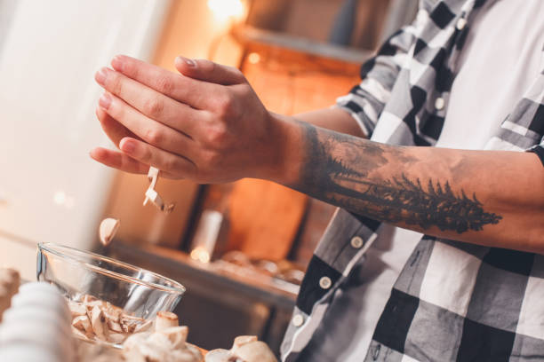 Closeup detail. Hands, tatto, sliced vegetable