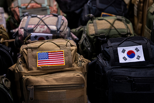 Backpacks with the flags of the United States and South Korea are displayed side-by-side outside a military surplus store in Itaewon, an area of Seoul, South Korea