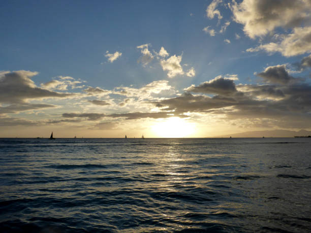 istock Dramatic Sunset over the clouds and reflecting on the Pacific ocean on the water with airplane flying 1183672773
