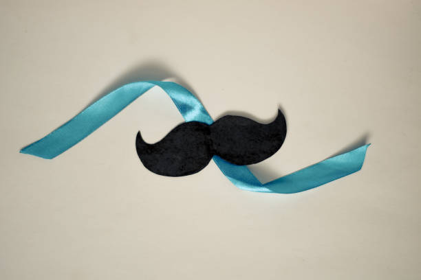istock Moustache on isolated background, blue ribbon, fathers day concept, with copy space 1183675485
