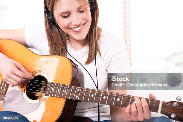 Smiling Young Woman Playing The Guitar Stock Photo - Download Image Now - 20-24 Years, 25-29 Years, Adult