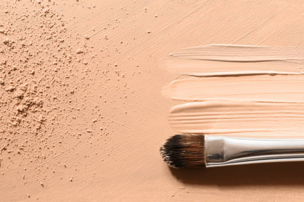 istock Makeup background. Liquid foundation, face powder texture and cosmetic brush 1183686310