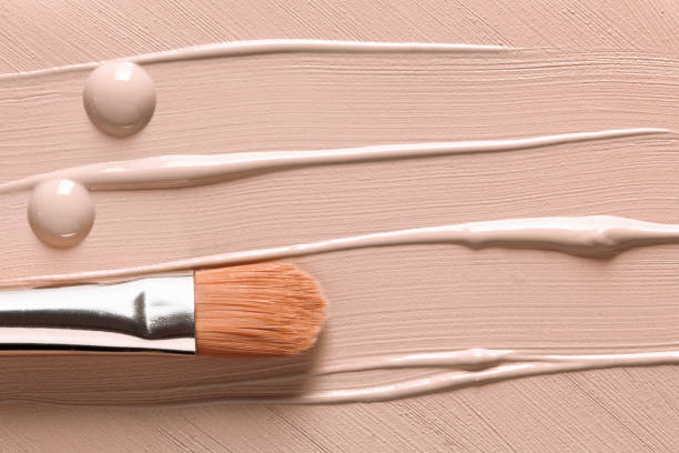 istock Makeup background. Liquid foundation texture and cosmetic brush 1183686312