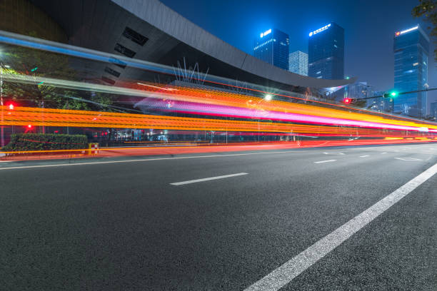 istock the light trails on the modern building background, shenzhen, china 1183687388
