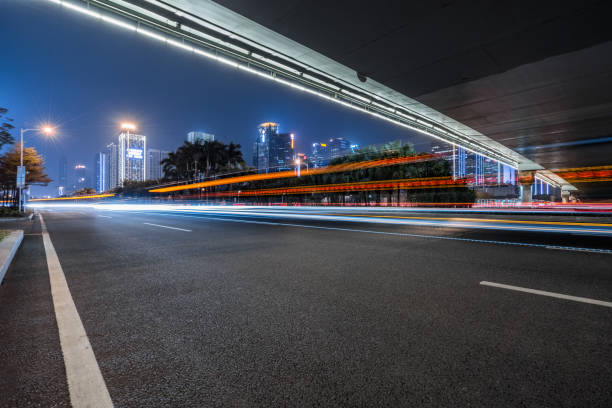 istock Vehicle light trails in city at night 1183687410