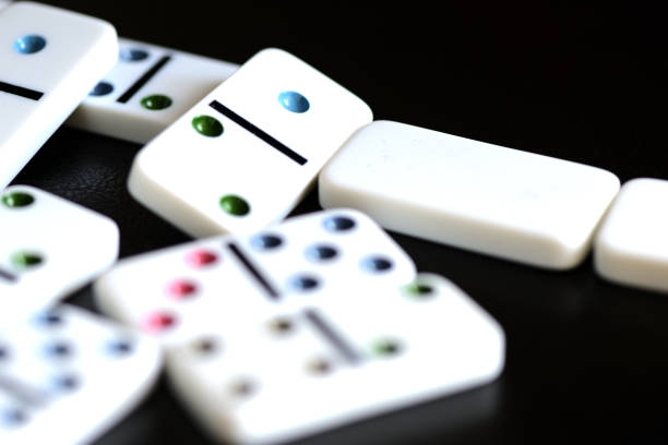 istock White domino on a black background close-up 1183698807