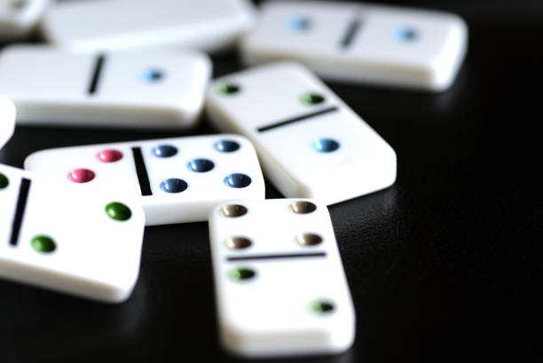 istock White domino on a black background close-up 1183698808