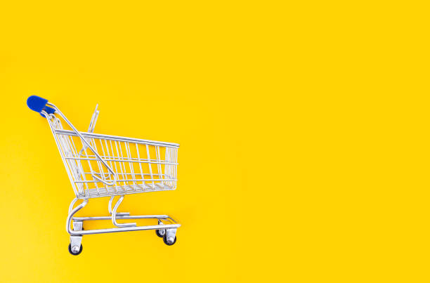 istock empty shopping cart over yellow background 1183699225