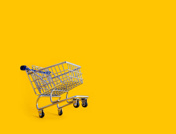 istock empty shopping cart over yellow background 1183699954