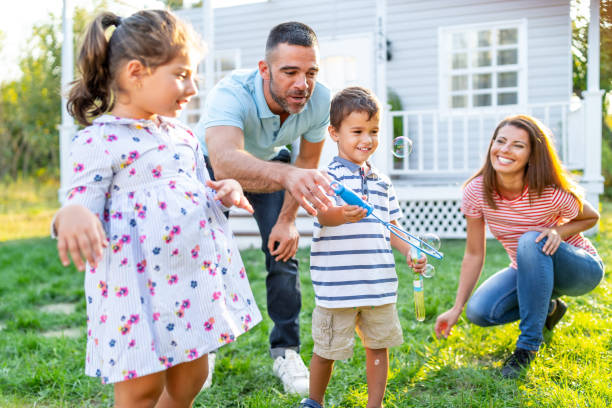 istock Family with two kids making bubbles in back yard 1183701068