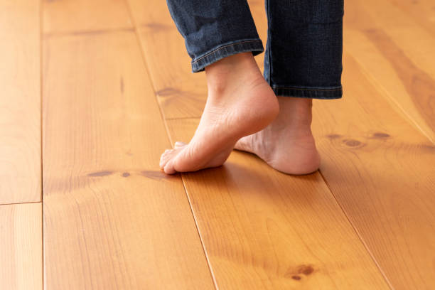 istock Wood floor and young woman's feet up 1183701632