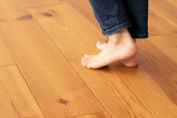 istock Wood floor and young woman's feet up 1183701637