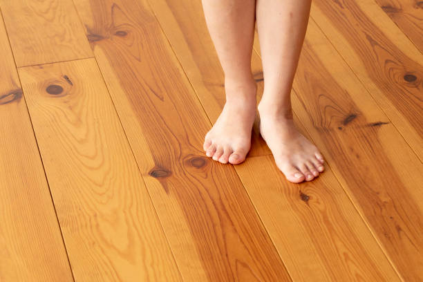 istock Wood floor and young woman's feet up 1183701657