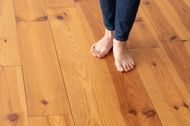istock Wood floor and young woman's feet up 1183701689