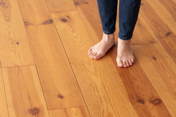 istock Wood floor and young woman's feet up 1183701706