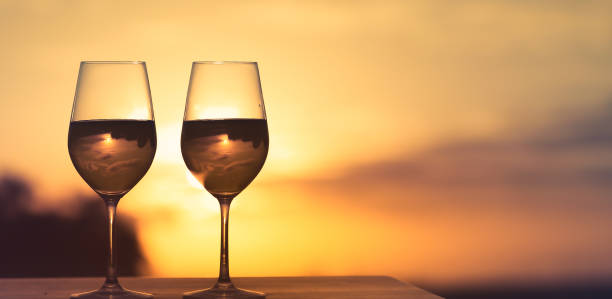 istock Pair of wine glasses against beautiful sunset. 1183702165